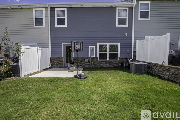 A house with a grey exterior and a white fence.