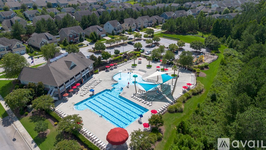 An aerial view of a swimming pool surrounded by a residential area.