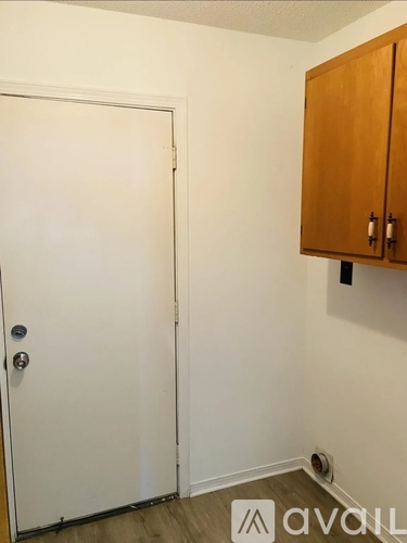 A white door with a silver handle is closed.