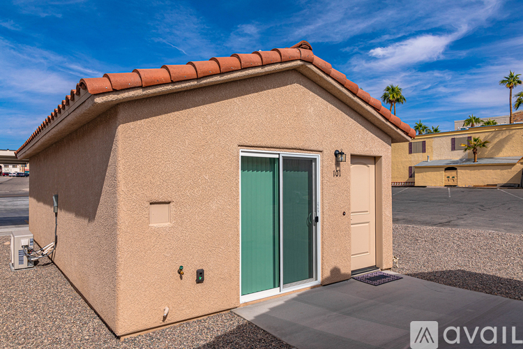 A small house with a green door is for sale.