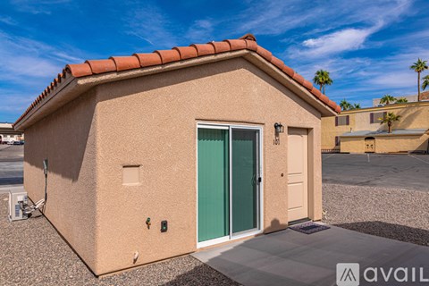 A small house with a green door is for sale.
