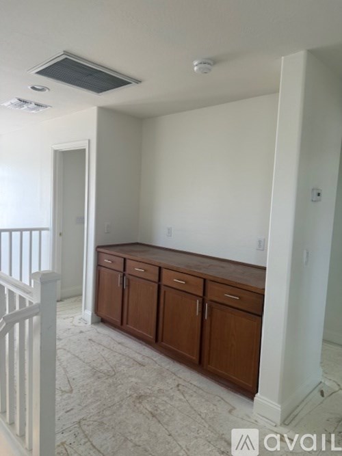 A room with a white ceiling and a cabinet.