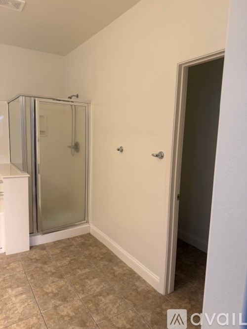 A bathroom with a walk-in shower and a toilet.