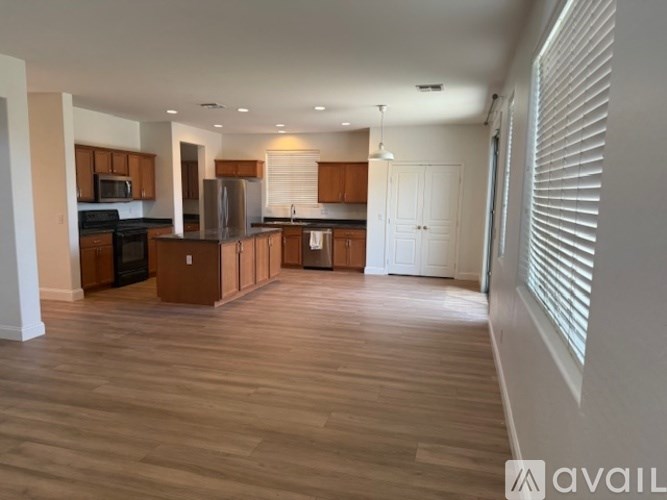 A kitchen with wooden floors and white walls.
