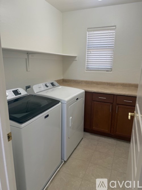 A small laundry room with a washer and dryer.