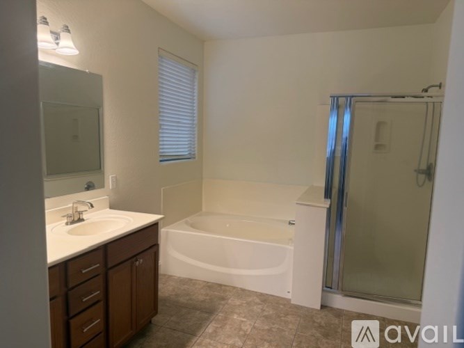 A bathroom with a bathtub, sink, and shower.