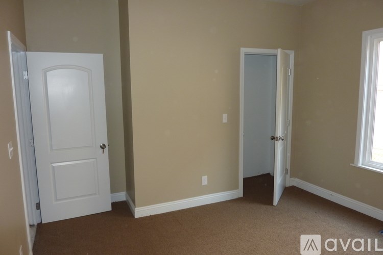 A room with two doors and a window.