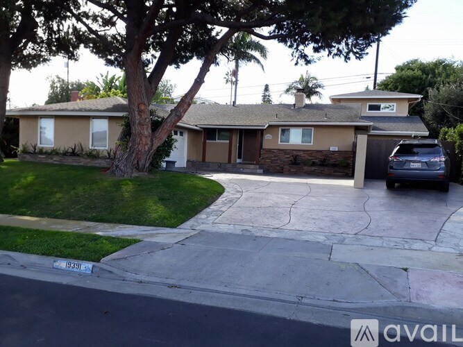 A house with a tree in front of it.