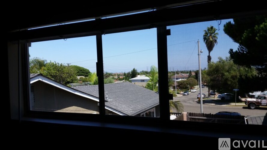 A view from a window looking out at a residential street.