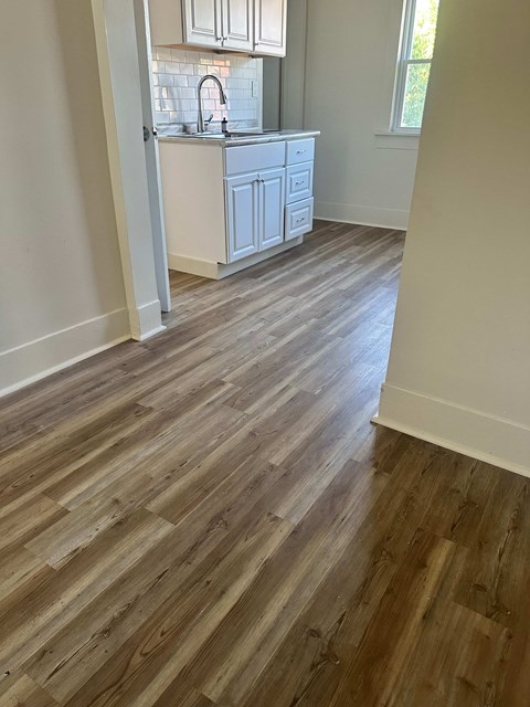 A kitchen with a white cabinet and a sink.