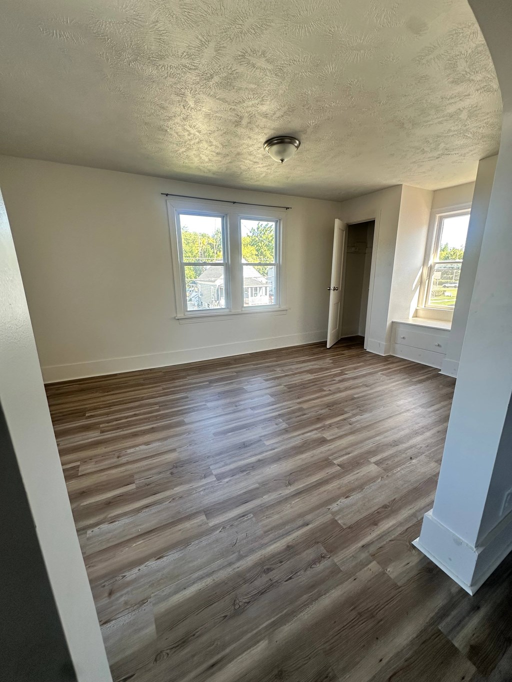A room with wooden floors and white walls.