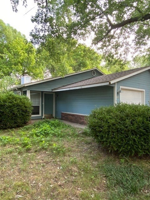 A blue house with a white door and a window.