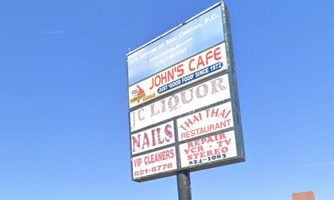 A sign for John's Cafe advertises nail salon and Thai restaurant services.