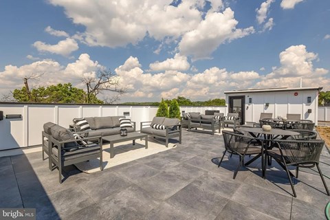 A patio with a table and chairs is set up on a rooftop.