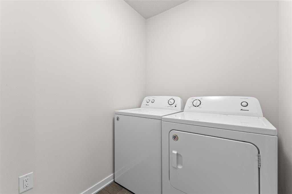 A white washing machine and dryer in a small laundry room.
