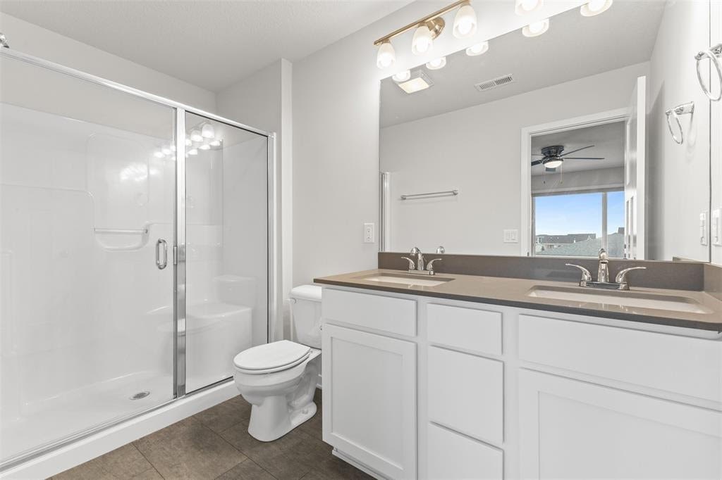 A white bathroom with a toilet, sink, and mirror.
