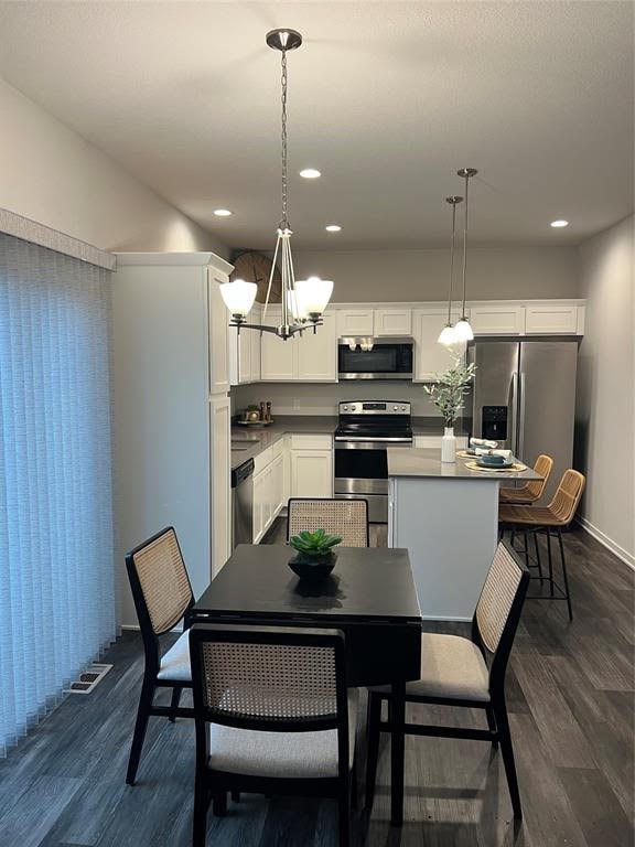 A modern kitchen with a dining table set for two.