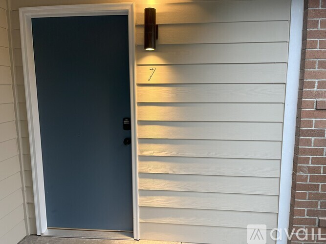 A blue door with a number 7 on the wall above it.