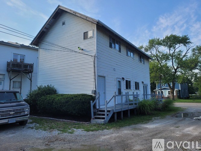 A house with a car parked in front of it.