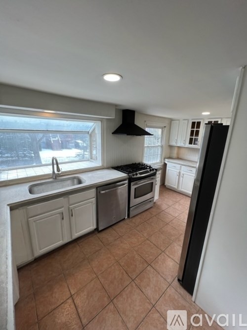 A kitchen with a sink, stove, and oven.
