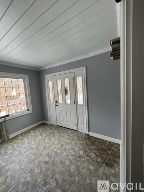 A room with a tiled floor and a window.
