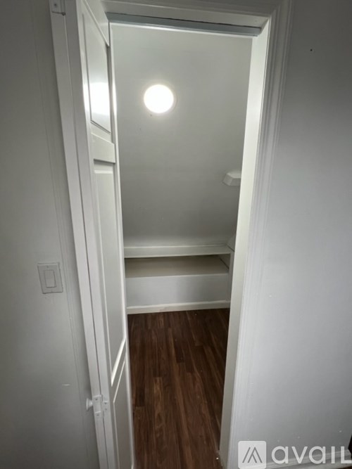 A white door with a light on the top.