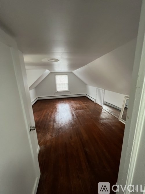 A room with wooden floors and white walls.