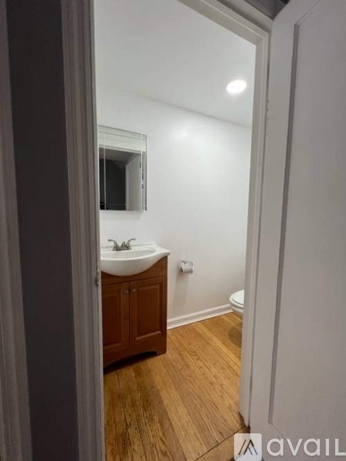 A bathroom with a sink and a mirror.