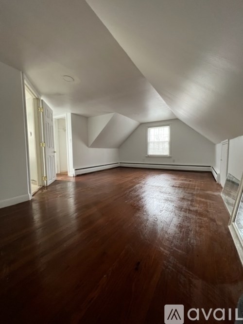 A room with wooden floors and white walls.