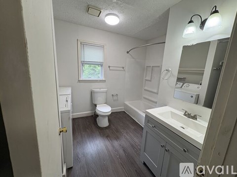 A room with wooden floors and a window.