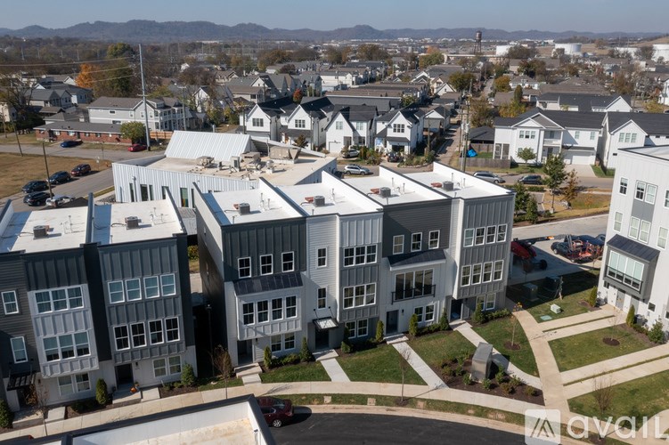 A large building complex with a parking lot in front.