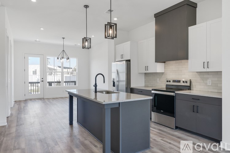 A kitchen with a large island and modern appliances.
