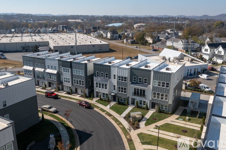 A large building complex with a parking lot in front.