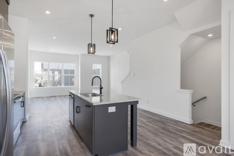 A kitchen with a sink and a refrigerator.