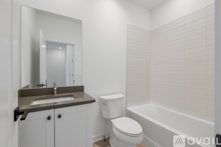 A bathroom with a sink, toilet and bathtub.