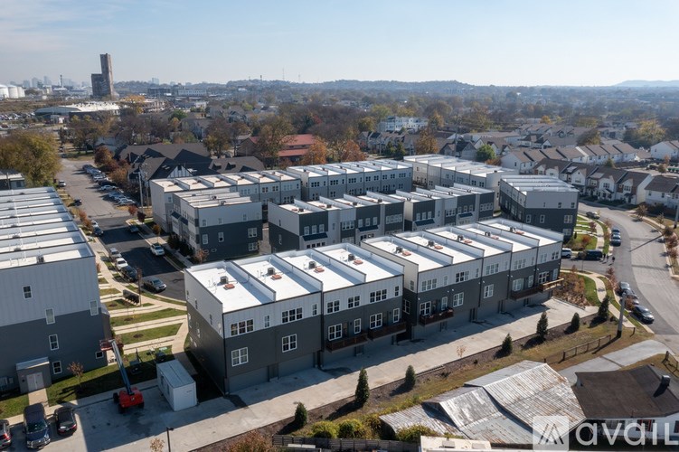 A large building complex with a parking lot in front.