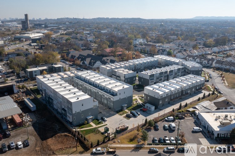 A large industrial building complex with a parking lot in front.