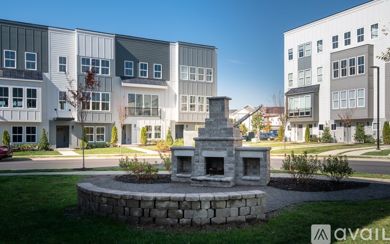 A modern building complex with a fountain in the foreground.