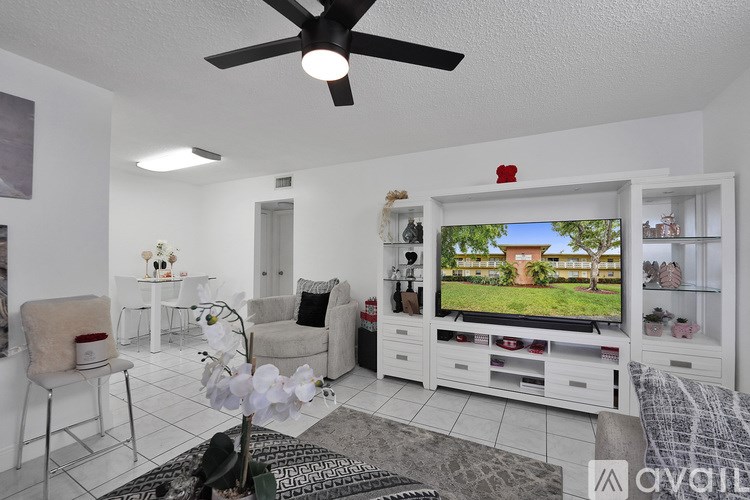 A living room with a television, a chair, and a table.