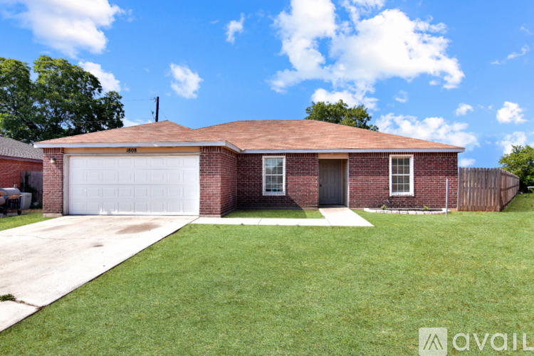 A brick house with a white garage door.