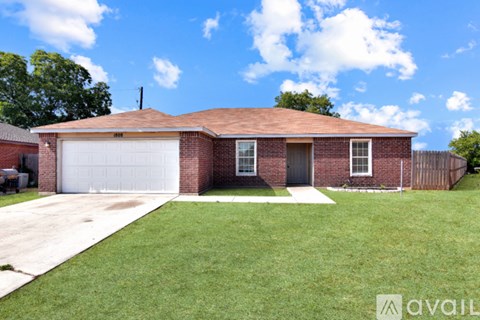 A brick house with a white garage door.