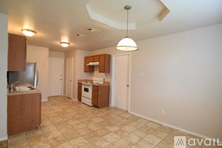 A kitchen area with a refrigerator, microwave, and oven.