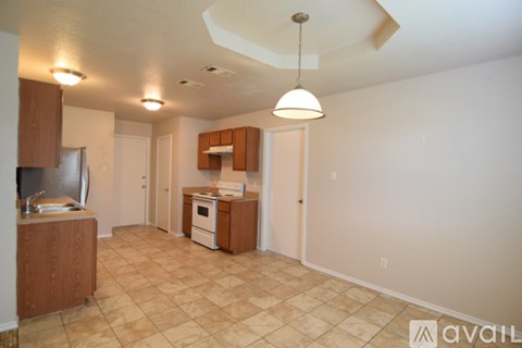 A kitchen area with a refrigerator, microwave, and oven.
