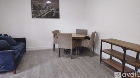 A living room with a couch, chair, and table.