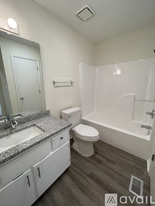 A bathroom with a sink, toilet, and bathtub.