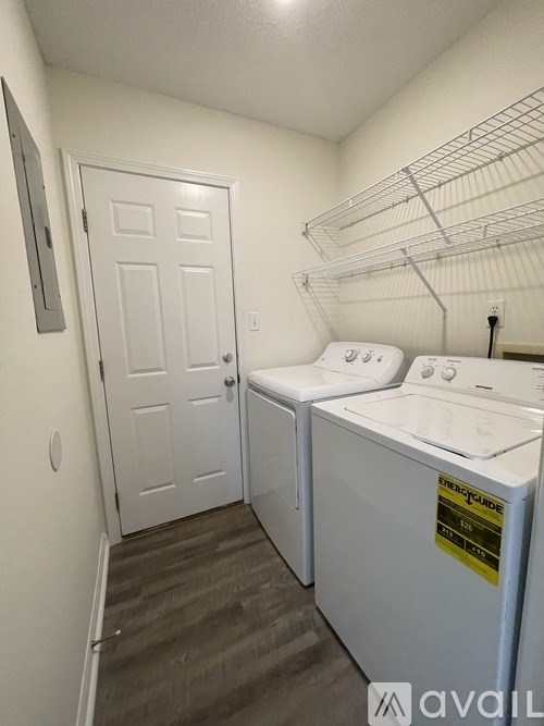 A small laundry room with a washer and dryer.