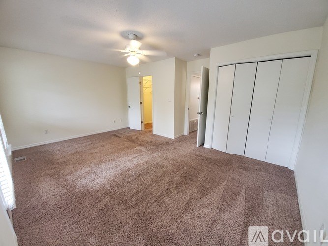 A room with brown carpeting and white walls.