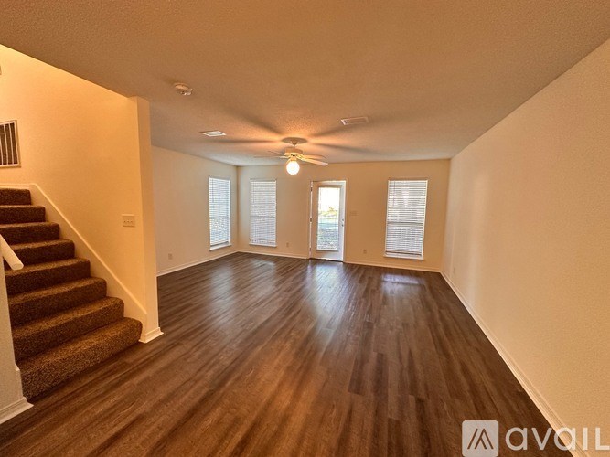 A kitchen with white cabinets and a granite countertop.