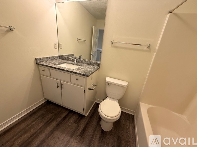 A kitchen with granite countertops and white cabinets.