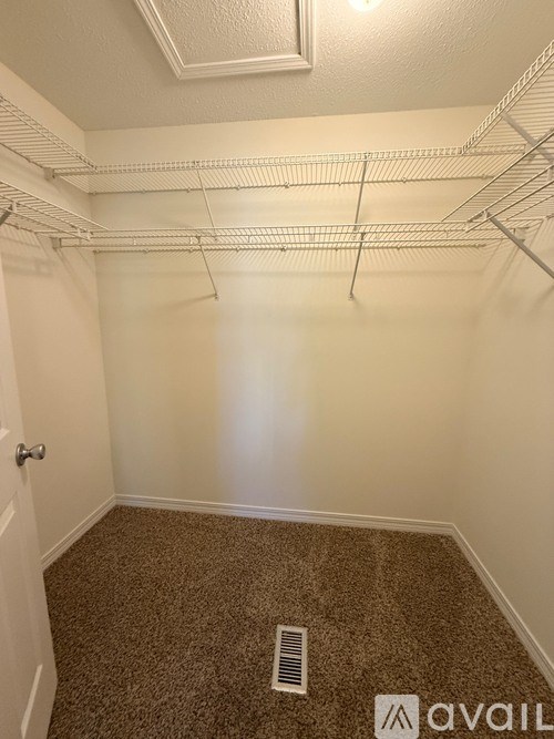 A long hallway with a bench and a light on the ceiling.